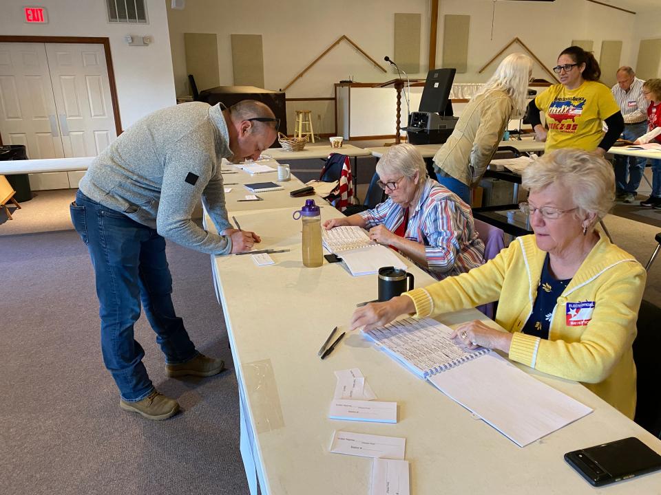 Christopher Lombardi got ready to vote at Grace Bible Church, polling place for Antrim Township 5, in the April 23 primary election. He’s shown with poll workers Cindy Ryder, left, and Nancy Taylor.