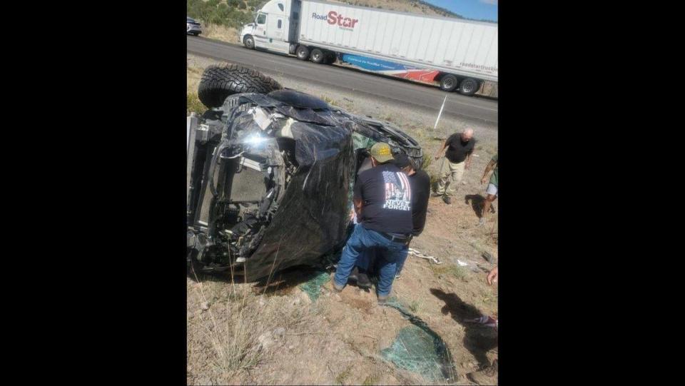 Gustine Police Department Reserve Officers Luciano Zelvaggio, left, and Jose Gallardo, right, pull a trapped motorist through the windshield of a crashed vehicle along Interstate 40 near Kingman, Ariz., on Monday, Sept. 11, 2023. According to the Gustine Police Department, three reserve officers stopped to pull the trapped man from the wreckage while driving newly acquired police department vehicles to California. Image courtesy of Gustine Police Department.