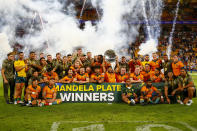 The Australian team celebrate after defeating South Africa to win the Nelson Mandela Plate during the Rugby Championship test match between the Springboks and the Wallabies in Brisbane, Australia, Saturday, Sept. 18, 2021. (AP Photo/Tertius Pickard)