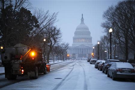 A general view of the U.S. Capitol in early morning snow in Washington, March 3, 2014. REUTERS/Jonathan Ernst