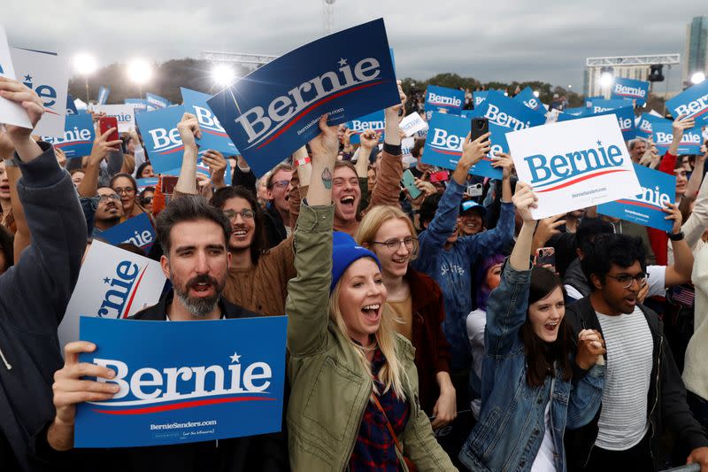 Supporters of Democratic U.S. presidential candidate Senator Bernie Sanders cheer as he takes the stage for an outdoor campaign rally in Austin