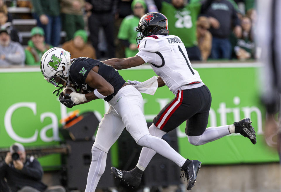 Marshall's Caleb McMillan, left, grabs a touchdown pass over Arkansas State's Samy Johnson (1) during an NCAA college football game Saturday, Nov. 25, 2023, in Huntington, W.Va. (Sholten Singer/The Herald-Dispatch via AP)