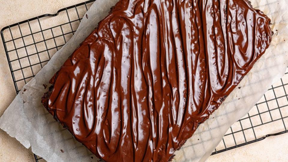 coca-cola cake recipe: birds eye view of finished cake with fudgy frosting on wire rack