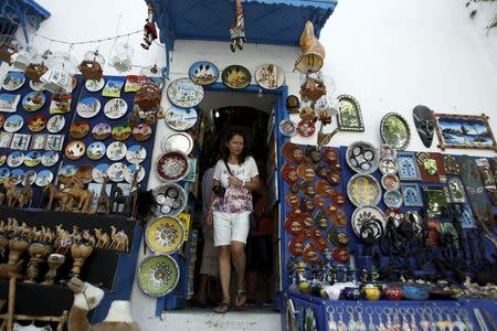 A tourist walks out of a traditional souvenir shop in Sidi Bou Said, near Tunis, Tunisia July 7, 2015. REUTERS/Zoubeir Souissi