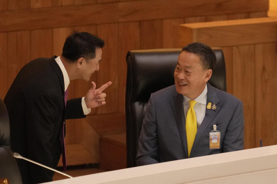 Thailand's Public Health Minister Chonlanan Srikaew, left, talks to Thailand's Prime Minister Srettha Thavisin at Parliament before read the policy statement at parliament in Bangkok, Thailand, Monday, Sept. 11, 2023. Srettha appeared before Parliament for the first time on Monday to lay out how his government envisions to improve the country during its four-year term. (AP Photo/Sakchai Lalit)