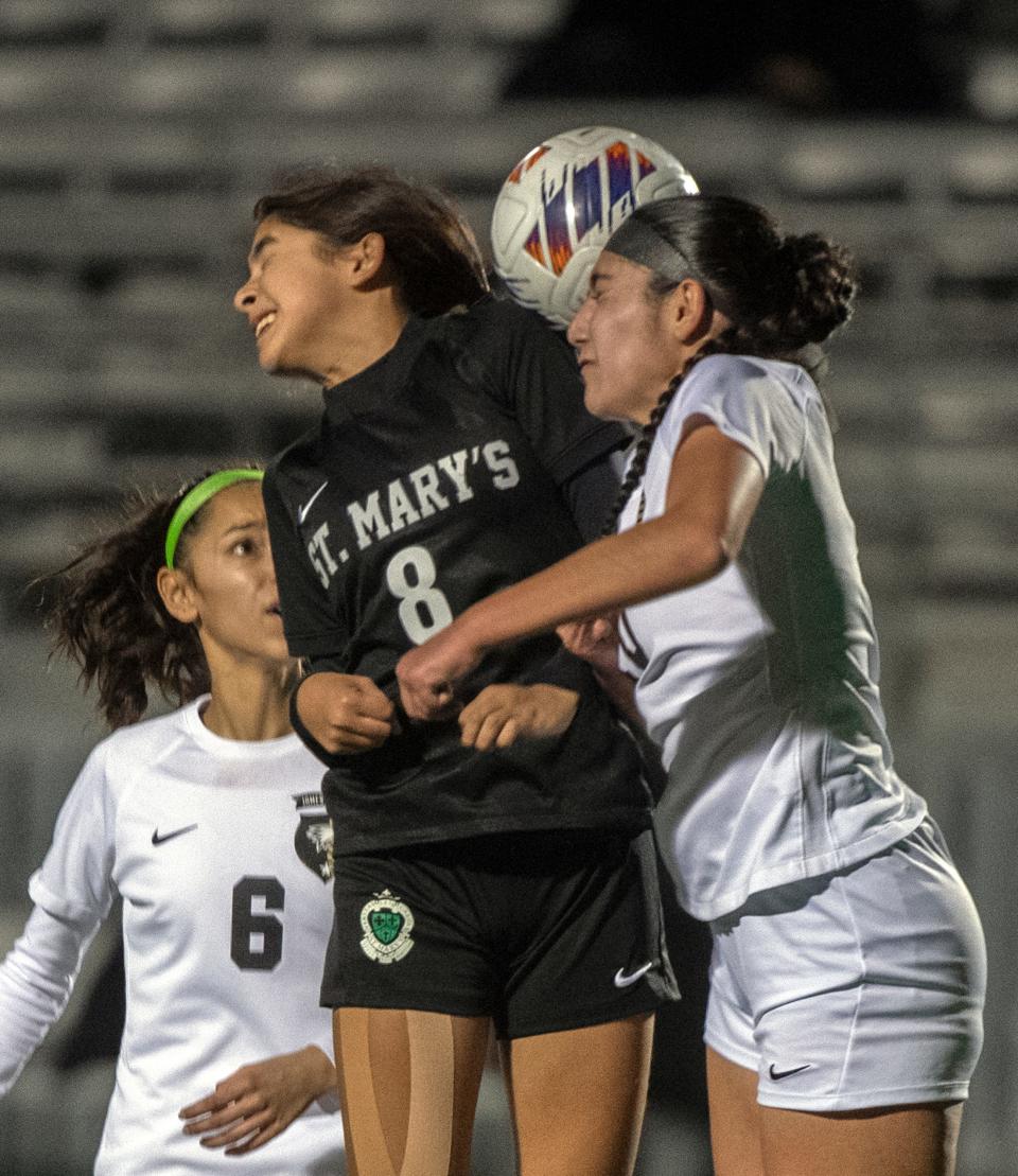 St. Mary's Alessandra Barajas, left, and Enoch's Olivia Marogi fight for a header during a Sac-Joaquin Section girls soccer playoff game at St. Mary's Sanguinetti Field in Stockton on Feb. 10, 2024.