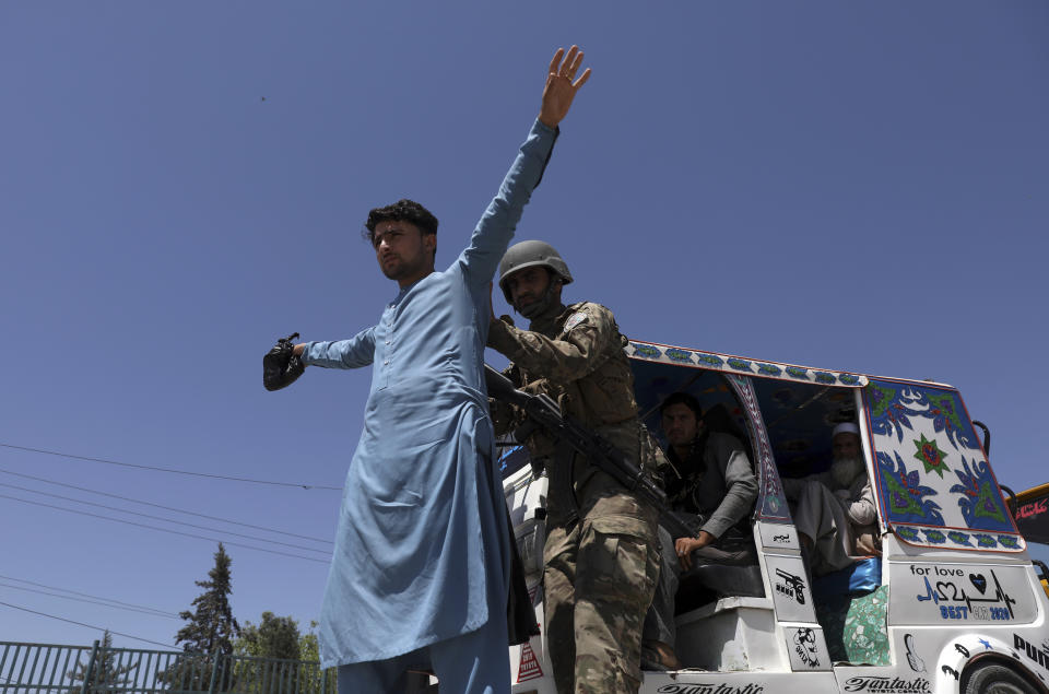 Afghan security police search a man at a checkpoint in Jalalabad, Afghanistan, Wednesday, April 21, 2021. America is winding up its longest war, calculating that the terrorist threat out of Afghanistan can’t reach to its shores and that threats to the West by militants can be defused from a distance. (AP Photo/Rahmat Gul)