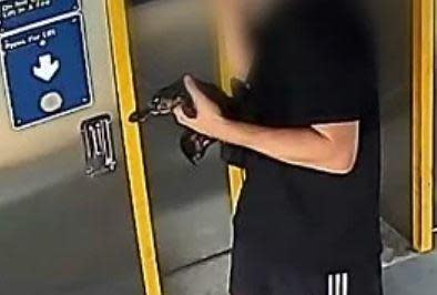 CCTV photos from Tuesday showed a man in flip-flops strolling along a train platform north of Brisbane while cradling the platypus -- about the size of a kitten -- under his arm. / Credit: Queensland Police