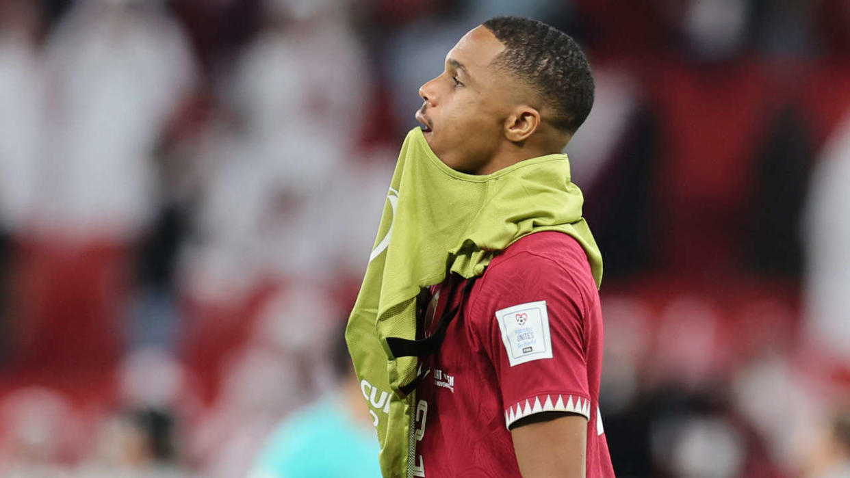 Qatar's defender #02 Pedro Miguel reacts to their defeat on the pitch after the Qatar 2022 World Cup Group A football match between Qatar and Senegal at the Al-Thumama Stadium in Doha on November 25, 2022. (Photo by KARIM JAAFAR / AFP)