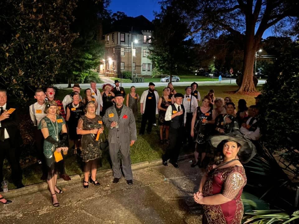 Murder mystery guests gather outside the Fitzgerald Museum in Montgomery in October 2021.