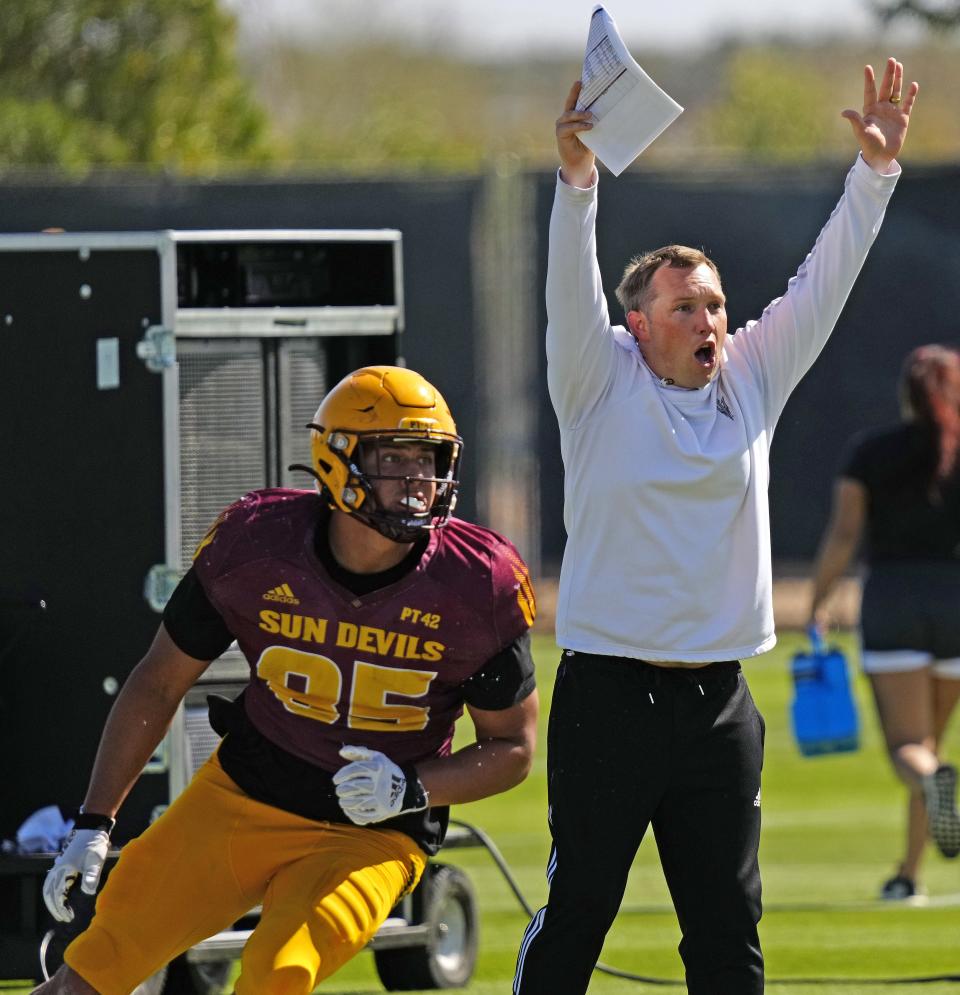 April 4, 2023; Phoenix, Ariz; USA; ASU head coach Kenny Dillingham yells to his team during spring practice at Kajikawa practice fields.