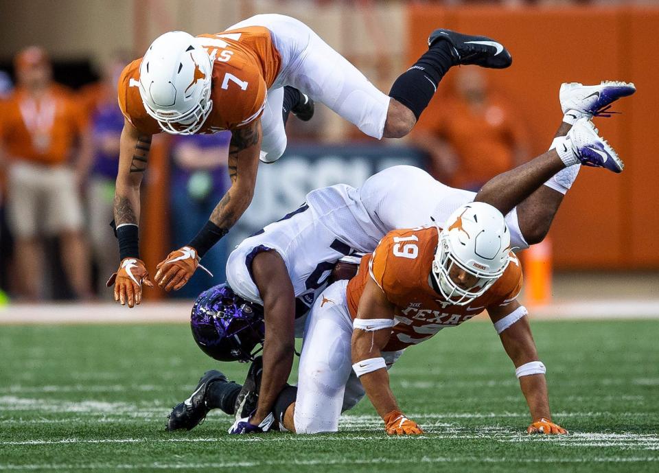 Texas defensive backs Brandon Jones, bottom, and Caden Sterns, top, team up to tackle TCU wide receiver Jarrison Stewart during their 2018 game at Royal-Memorial Stadium. Jones and Sterns have reunited, along with former Longhorns P.J. Locke and Lil'Jordan Humphrey, as members of the Denver Broncos.