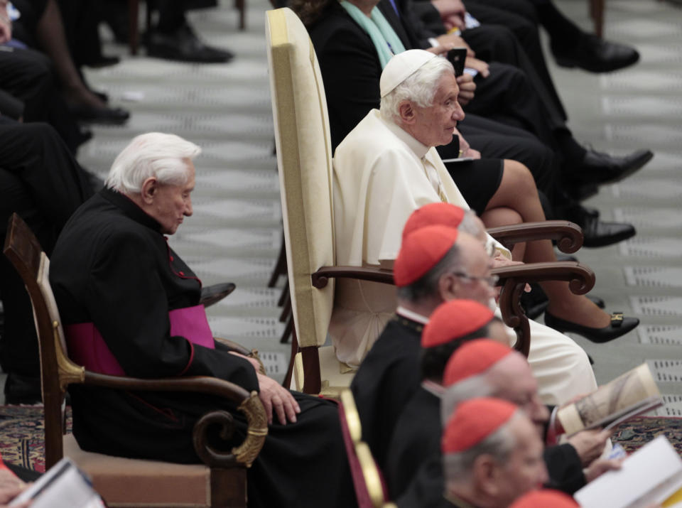 FILE - In this Friday, April 20, 2012 file photo, Pope Benedict XVI and his brother Monsignor Georg Ratzinger, left, listen to a concert offered by the Leipzig Gewandhaus Orchestra directed by Riccardo Chailly on the occasion of Pontiff's 85th birthday celebrations in the Paul VI hall at the Vatican.The Rev. Georg Ratzinger, the older brother of Emeritus Pope Benedict XVI, who earned renown in his own right as a director of an acclaimed German boys’ choir, has died at age 96. The Regensburg diocese in Bavaria, where Ratzinger lived, said in a statement on his website that he died on Wednesday, July 1, 2020. (AP Photo/Gregorio Borgia, File)