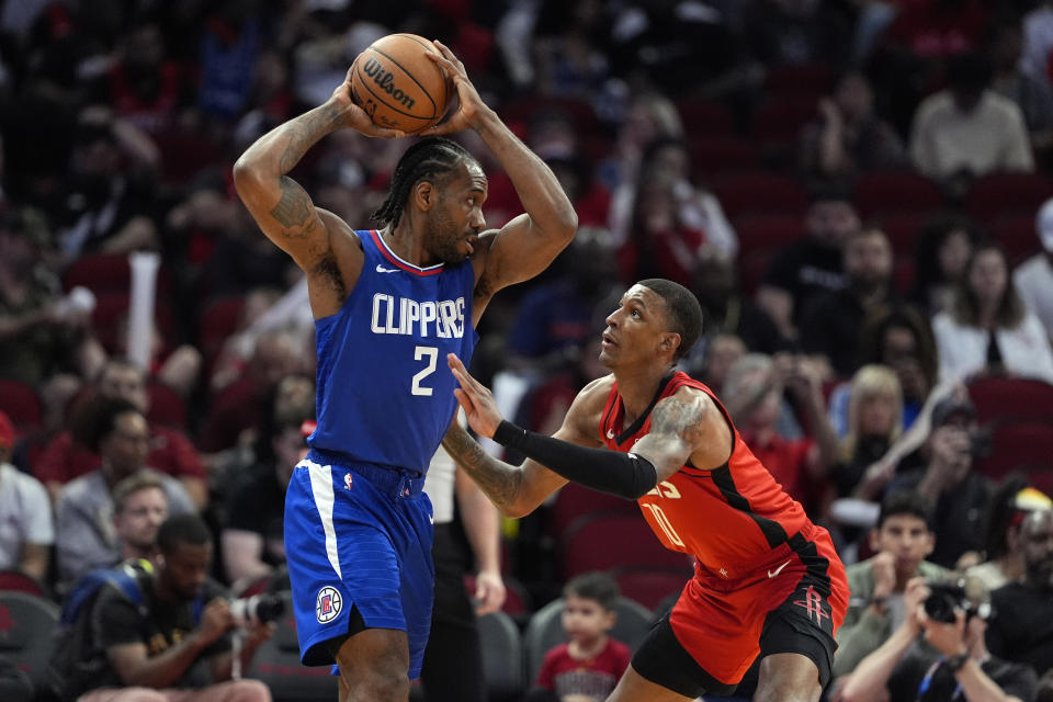 Houston Rockets' Jabari Smith Jr. (10) defends agaisnt Los Angeles Clippers' Kawhi Leonard (2) during the first half of an NBA basketball game Wednesday, March 6, 2024, in Houston. (AP Photo/David J. Phillip)