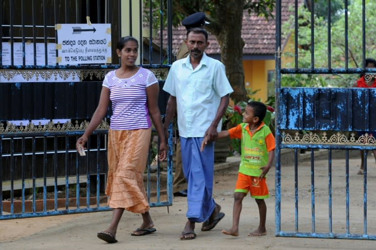 Sri Lankan voters leave after casting their ballot at a polling station in Tangalla, some 195 kms from the capital Colombo, on August 17, 2015