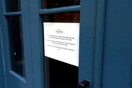 A sign posted on a restaurant's entrance is photographed as Tropical Storm Barry approaches land in New Orleans