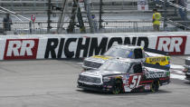 Kyle Busch (51) leads Grant Enfinger (98) during a restart in the NASCAR Truck Series auto race at Richmond International Raceway in Richmond, Va., Saturday, April 17, 2021. (AP Photo/Steve Helber)