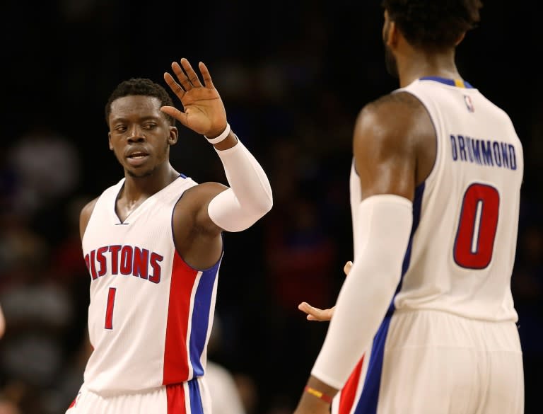 Reggie Jackson (L) and Andre Drummond of the Detroit Pistons celebrate scoring a basket during a NBA game at the Palace of Auburn Hills in Michigan, in 2015