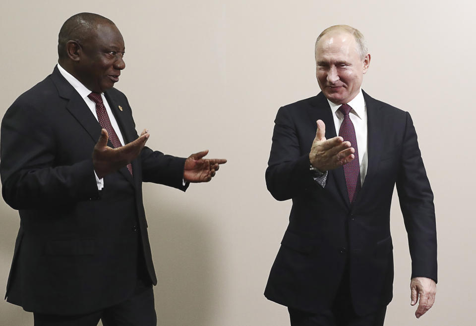 Russian President Vladimir Putin, right, welcomes South Africa's President, Cyril Ramaphosa on the sideline of the Black Sea resort of Sochi, Russia, Wednesday, Oct. 23, 2019. (Sergei Fadeyechev, TASS News Agency Pool Photo via AP)