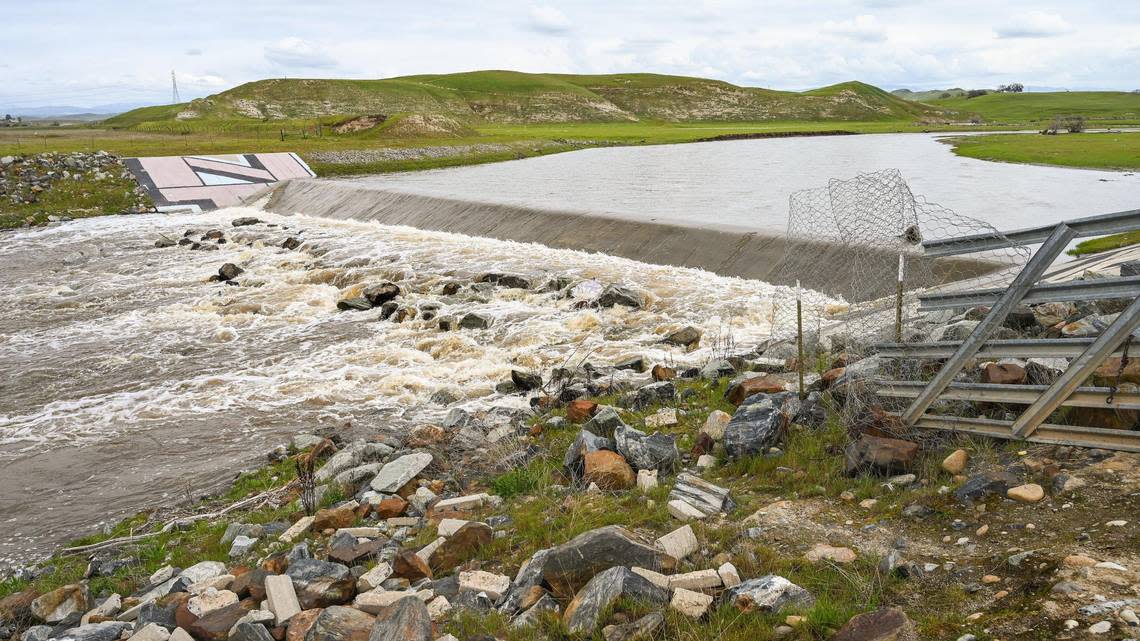 Water swells along the banks of the Dry Creek overflow while moving toward the San Joaquin River near Ball Ranch on North Friant Road on Wednesday, March 8, 2023. Heavy rain from a warm atmospheric river is forecast for the next few days causing alarm for possible flooding.