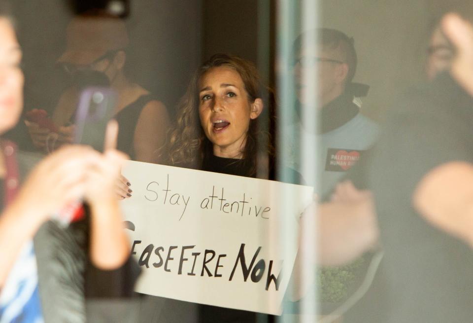 Activists protest in the lobby outside of Sen. Mark Kelly's office in Phoenix on Nov. 14, 2023.