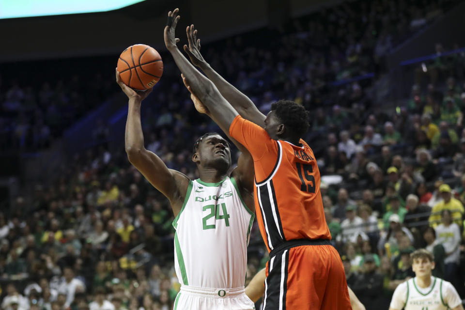 Oregon forward Mahamadou Diawara (24) tries to shoot over Oregon State center Chol Marial (15) during the first half of an NCAA college basketball game Wednesday, Feb. 28, 2024, in Eugene, Ore. (AP Photo/Amanda Loman)