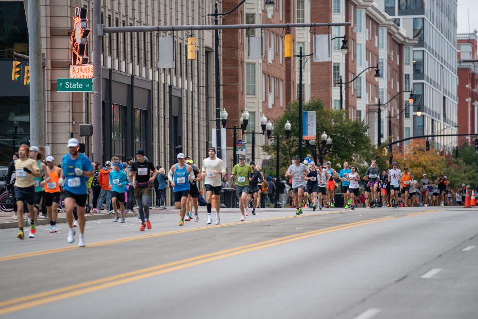 Participants of the Nationwide Children’s Hospital Columbus Marathon and Half Marathon arrive at the Ohio Statehouse on South High Street coming close to the midway point of the marathon.