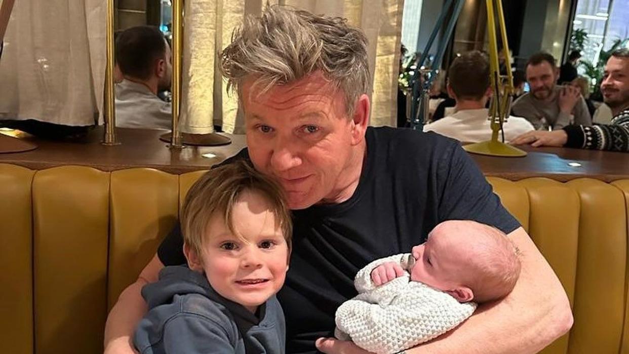 gordon holding jesse and cuddling oscar