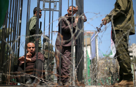 Men play the role of jailed Palestinians and Israeli soldiers during a rally in support of Palestinian prisoners on hunger strike in Israeli jails, in Gaza City April 17, 2017. REUTERS/Mohammed Salem