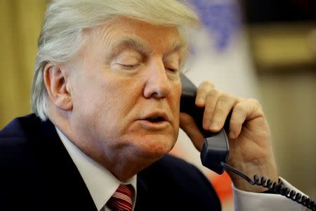 U.S. President Donald Trump waits on the line as he calls Irish Prime Minister Leo Varadkar to congratulate him on his victory in the Oval Office of the White House in Washington, U.S., June 27, 2017. REUTERS/Carlos Barria