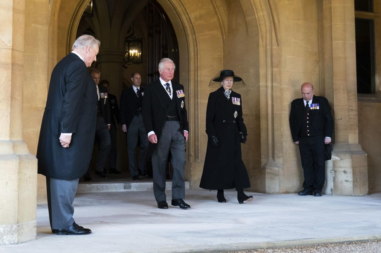 Prince Charles and Princess Anne follow the Land Rover Defender carrying Prince Philip's coffin during the funeral in Windsor Castle, Windsor, England, Saturday April 17, 2021.