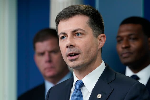 FILE - Transportation Secretary Pete Buttigieg, center, speaks during a briefing at the White House in Washington, May 16, 2022, as Labor Secretary Marty Walsh, left, and Environmental Protection Agency administrator Michael Regan, right, listen. Buttigieg says he is pushing airlines to hire more customer-service people and take other steps to help travelers this summer. (AP Photo/Susan Walsh, File) (Photo: via Associated Press)