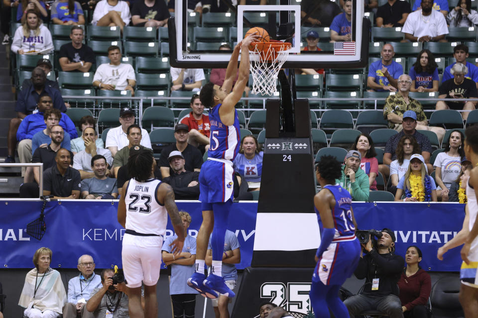 Kansas guard Kevin McCullar Jr. (15) dunks against Marquette during the first half of an NCAA college basketball game Tuesday, Nov. 21, 2023, in Honolulu. (AP Photo/Marco Garcia)
