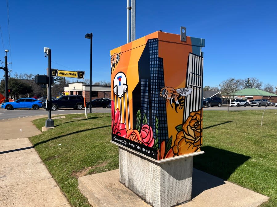 Photo of new box wrap depicting a Tyler water tower, roses, downtown buildings and a bee.