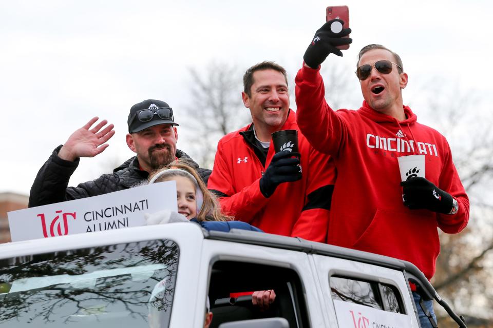 Grand marshal Kevin Youkilis, far left, waves during the University of Cincinnati Homecoming Parade in 2019.