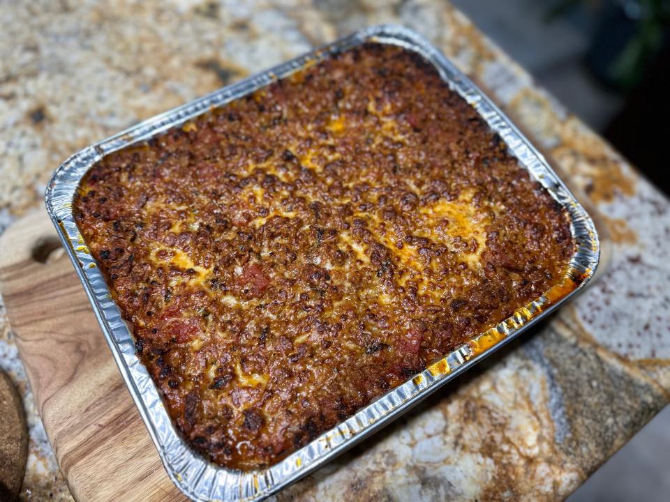 cooked meat lasagna in a pan on a kitchen counter