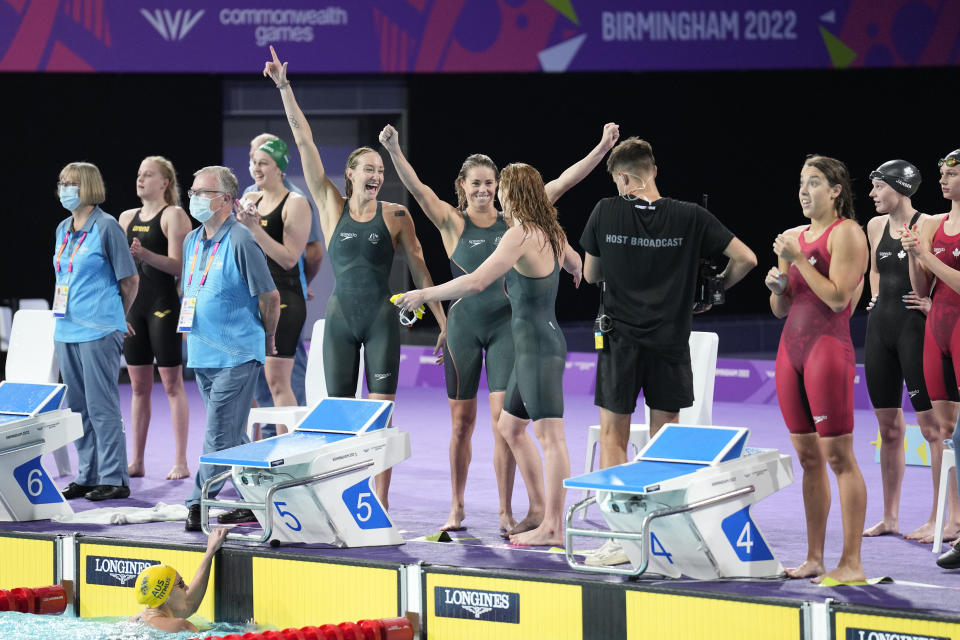 Australian's Women's 4 x 200m Freestyle Relay team react as they win the final in a world record time during the swimming at the Commonwealth Games in Sandwell Aquatics Centre in Birmingham, England, Sunday, July 31, 2022. (AP Photo/Aijaz Rahi)