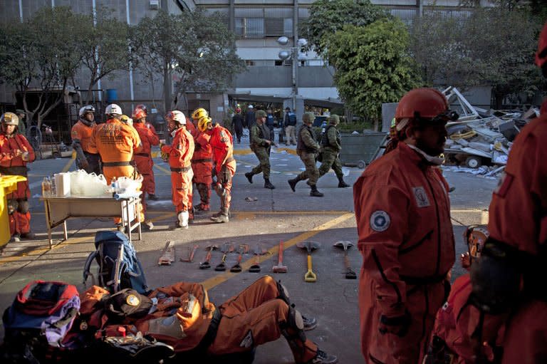 A rescue member takes a break from the search for victims at the headquarters of state-owned Mexican oil giant Pemex in Mexico City on February 1, 2013