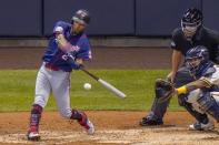 Minnesota Twins' Eddie Rosario hits a single during the fifth inning of a baseball game against the Milwaukee Brewers Monday, Aug. 10, 2020, in Milwaukee. (AP Photo/Morry Gash)