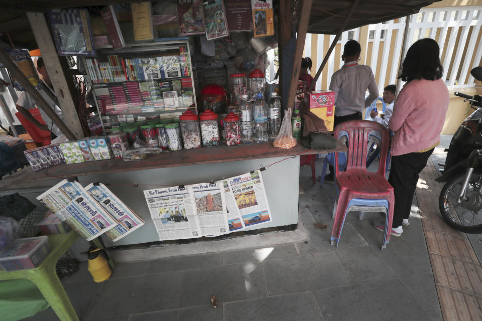 Local newspapers Nokor Thum, two copies at left, in the Khmer language, the Phnom Penh Post, center, and Khmer Times are for sale at a newspaper's stand on a sidewalk near Monument Independence in Phnom Penh, Cambodia, Friday, Mach 1, 2024. The Phnom Penh Post, a newspaper founded in 1992 as Cambodia sought to re-establish stability and democracy after decades of war and unrest, announced Friday that it will cease publishing a print edition this month, the latest blow to the country's dwindling independent media. (AP Photo/Heng Sinith)