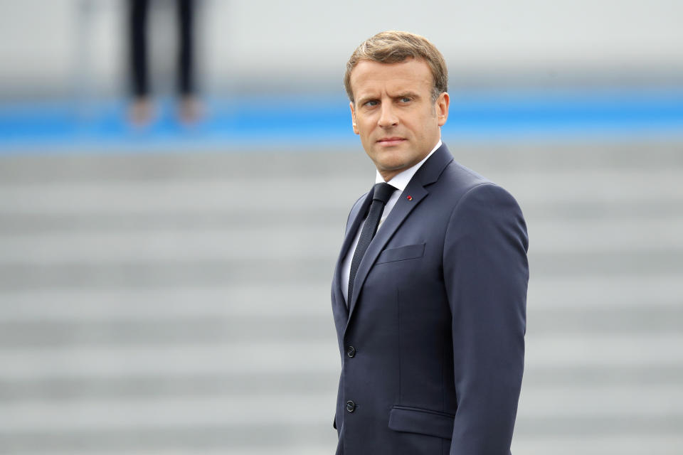 France's President Emmanuel Macron reviews troops before the start of the Bastille Day military parade, Tuesday, July 14, 2020 in Paris. France are honoring nurses, ambulance drivers, supermarket cashiers and others on its biggest national holiday Tuesday. Bastille Day's usual grandiose military parade in Paris is being redesigned this year to celebrate heroes of the coronavirus pandemic. (AP Photo/Christophe Ena, Pool)