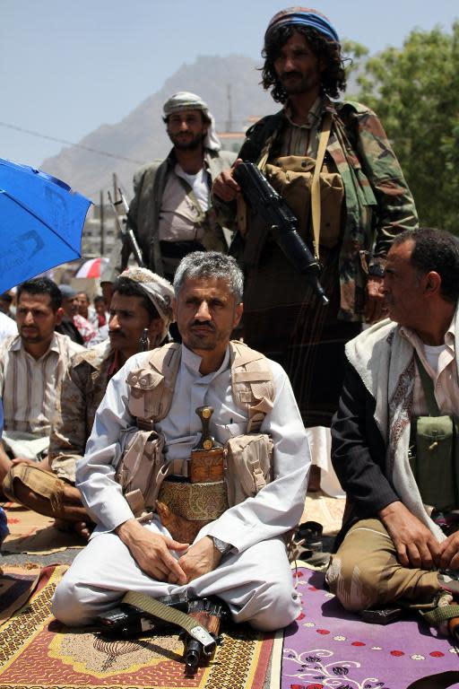 Hammud Said al-Mikhlafi (C), commander of the Popular Resistance Committees loyal to President Abedrabbo Mansour Hadi, is seen kneeling during Friday prayers in the southwestern Yemeni city of Taez on April 17, 2015