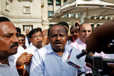 H. D. Kumaraswamy (C), Janata Dal (Secular) leader and former Chief Minister of the southern state of Karnataka, speaks to the media outside the legislative house after a vote of confidence motion against the ruling Bharatiya Janata Party's (BJP) B. S. Yeddyurappa's government, in Bengaluru, India, May 19, 2018. REUTERS/Abhishek N. Chinnappa