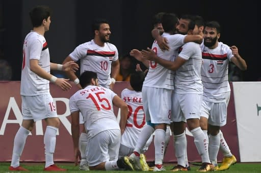 Syria football players celebrate after scoring against Palestine at the Asian Games in Indonesia on August 23, 2018