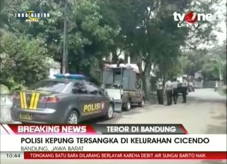 A still image from video shows police personnel along a street after an explosion at a government building in Bandung city, Indonesia February 27, 2017. TV ONE/via Reuters TV.