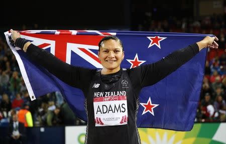 Valerie Adams of New Zealand celerbates her gold medal finish with the flag after the Women's Shot Put final at the 2014 Commonwealth Games in Glasgow, Scotland, July 30, 2014 REUTERS/Suzanne Plunkett