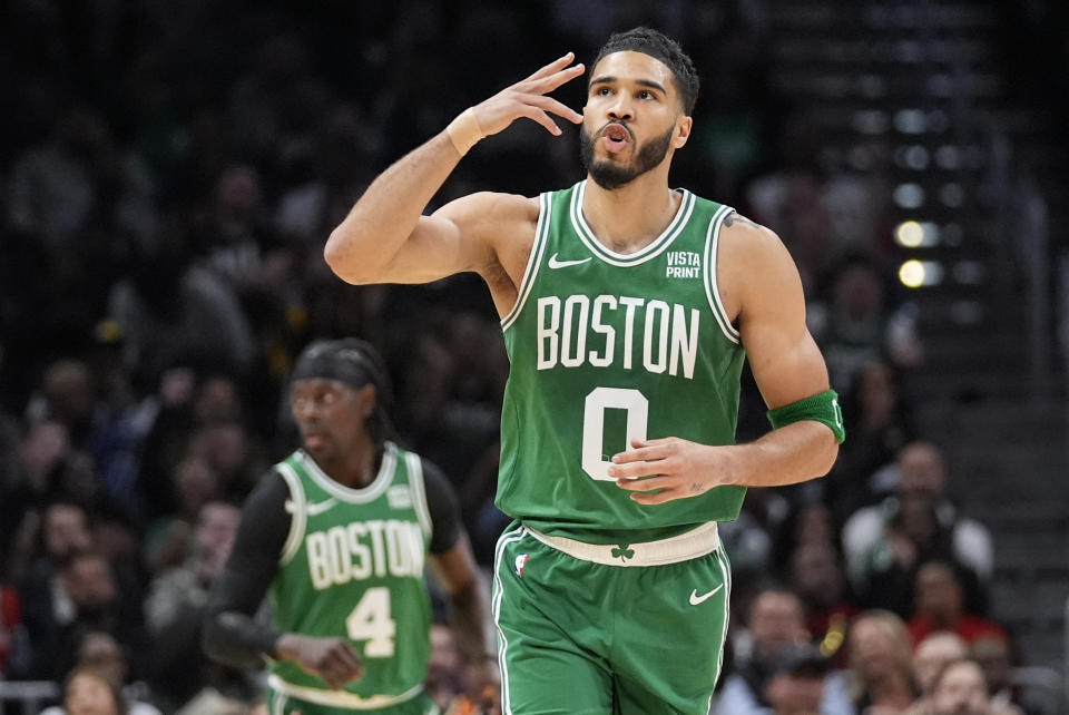 Boston Celtics forward Jayson Tatum (0) reacvts after a three-point basket during the first half of an NBA basketball game against the Atlanta Hawks Thursday, March 28, 2024, in Atlanta. (AP Photo/John Bazemore)