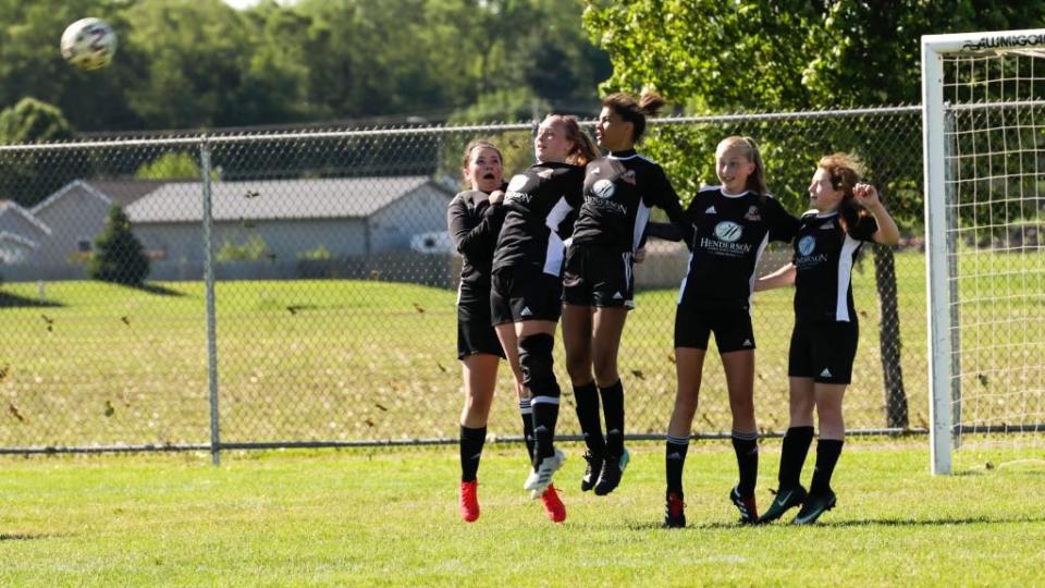 A wall of Pekin Pride U15 girls players reacts to a free kick during a game in the 2021 Kickoff to Summer Classic tournament. From left are Molly Cottrell, Josie Scally, Cali Zimmerman, Alison Barnum and Katelyn Stolz.