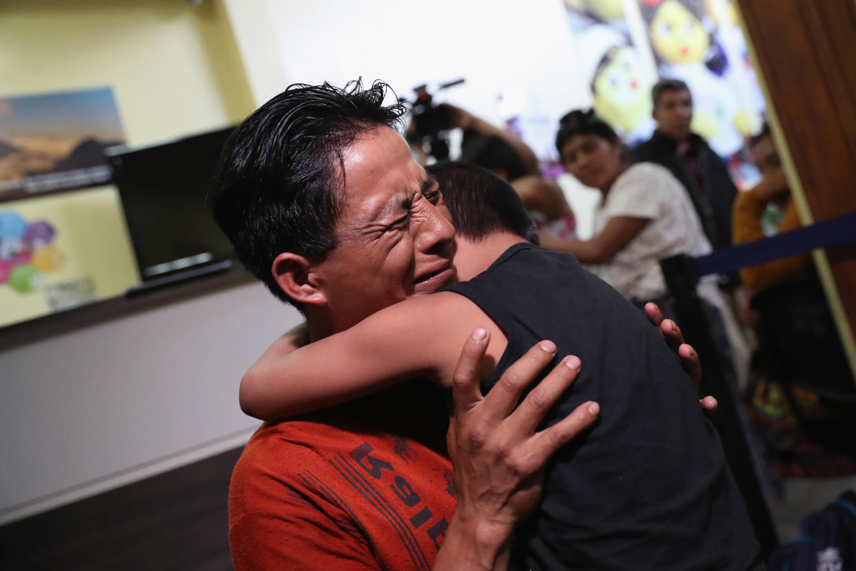 An emotional father embraces his son for the first time in months on Aug. 7, 2018, in Guatemala City, after nine children were flown from New York to reunite with their families. (Photo: John Moore/Getty Images)