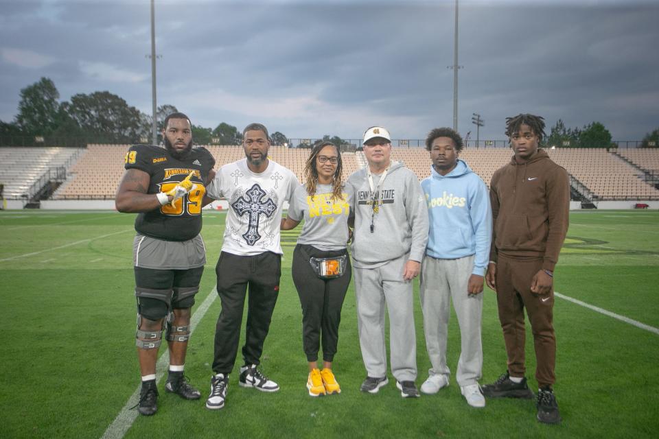 Former Pine Forest defensive lineman Pooda Walker (left) joins the family of Ladarius "LD" Clardy after earning the Ladarius "LD" Clardy Memorial Impact Award at Kennesaw State.